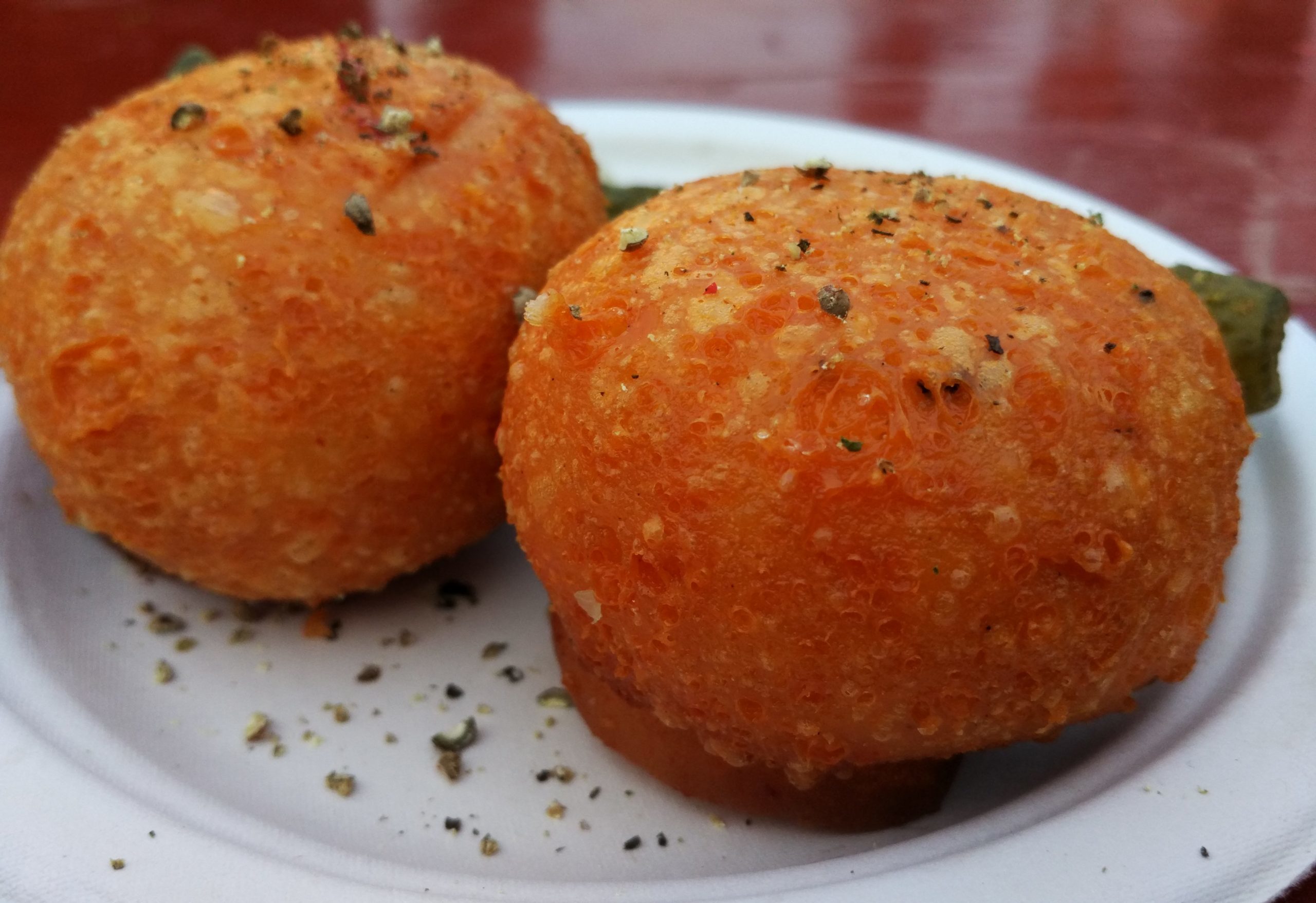 two person holding fork dipping food on sauce